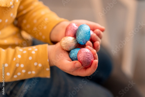 Canvas Print toddler holding a chocolate eggs