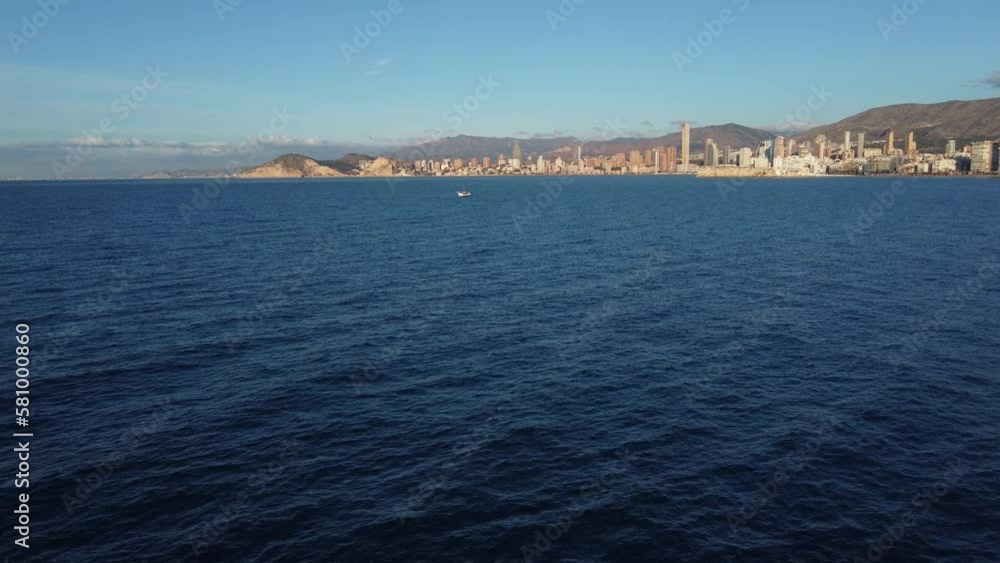 Aerial view of Benidorm. Approaching a fishing boat in the bay. Aerial view of Benidorm. Approaching a fishing boat in the bay.