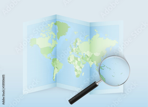 A folded world map with a magnifying lens pointing towards Vanuatu. Map and flag of Italy in loupe.