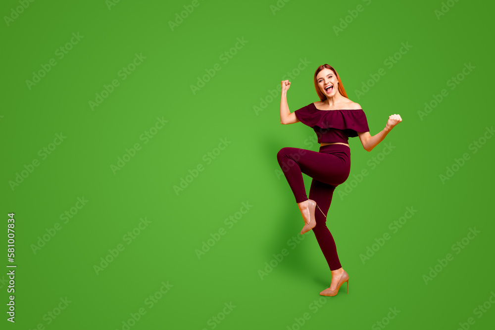 Full body size length view photo portrait of funky comic cool nice glad cheerful joyful carefree girl wearing burgundy suit running going moving lady raising fists up isolated bright background Full body size length view photo portrait of funky comic cool nice glad cheerful joyful carefree girl wearing burgundy suit running going moving lady raising fists up isolated bright background