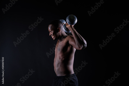 Muscular black african man with defined muscles abs abdominal, exercise determination and success