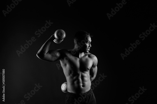 Muscular black african man with defined muscles abs abdominal, exercise determination and success © Ivan Zelenin