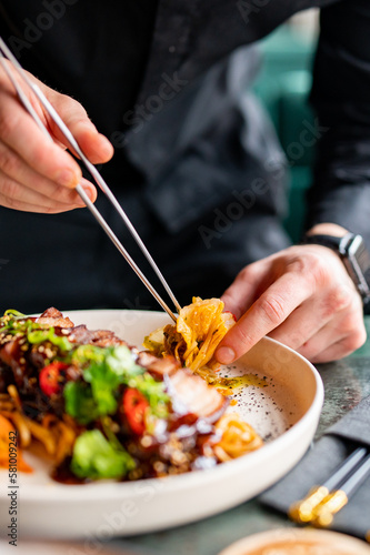 chef hands decorated food on plate photo