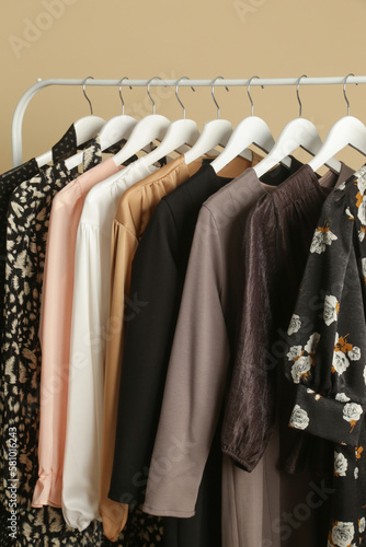 Women's Clothes. Clothes rack with stylish and elegant garments in fashion atelier. Good quality timeless fashion pieces.
