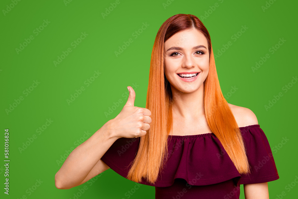 Charming girl in casual clothes shows thumbs up and smiles looking at camera isolated on yellow background Charming girl in casual clothes shows thumbs up and smiles looking at camera isolated on yellow background