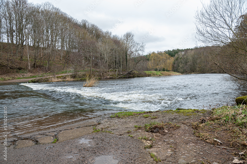 Fototapeta premium Etal Ford through the River Till after heavy rain, Northumberland, England