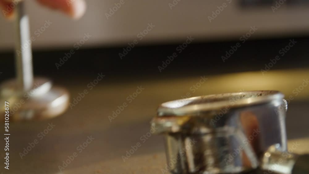 closeup of a coffee getting pressed down in a portafilter closeup of a coffee getting pressed down in a portafilter