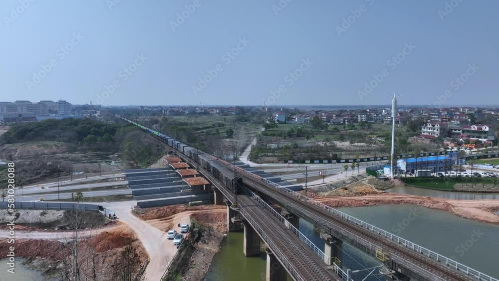 view of cargo train through bridge view of cargo train through bridge