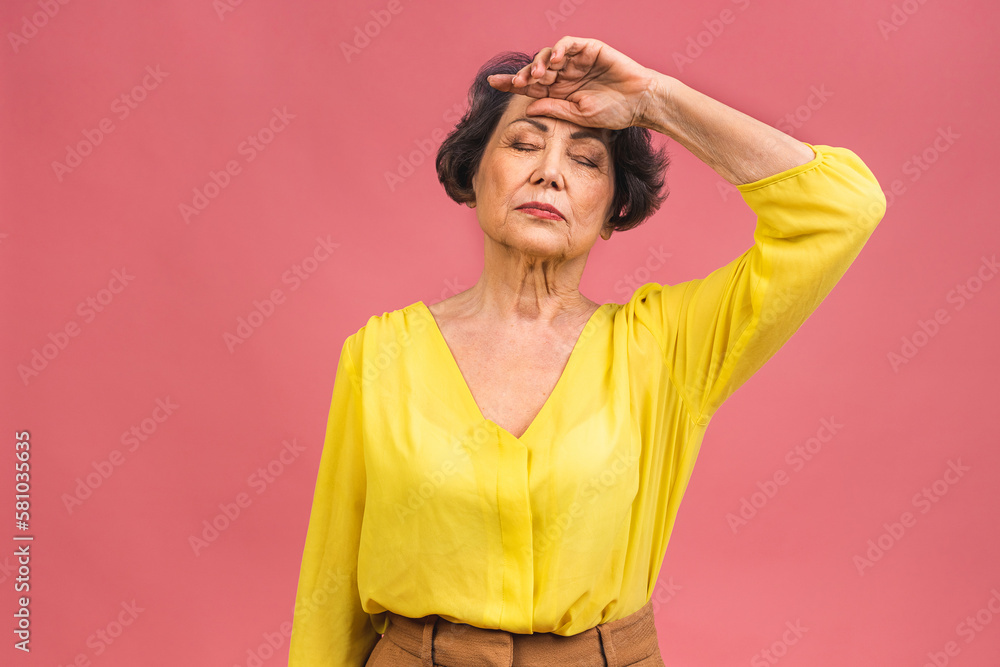Portrait of stressed tired ill mature senior aged woman isolated over pink background. Grandmother headache concept. Portrait of stressed tired ill mature senior aged woman isolated over pink background. Grandmother headache concept.
