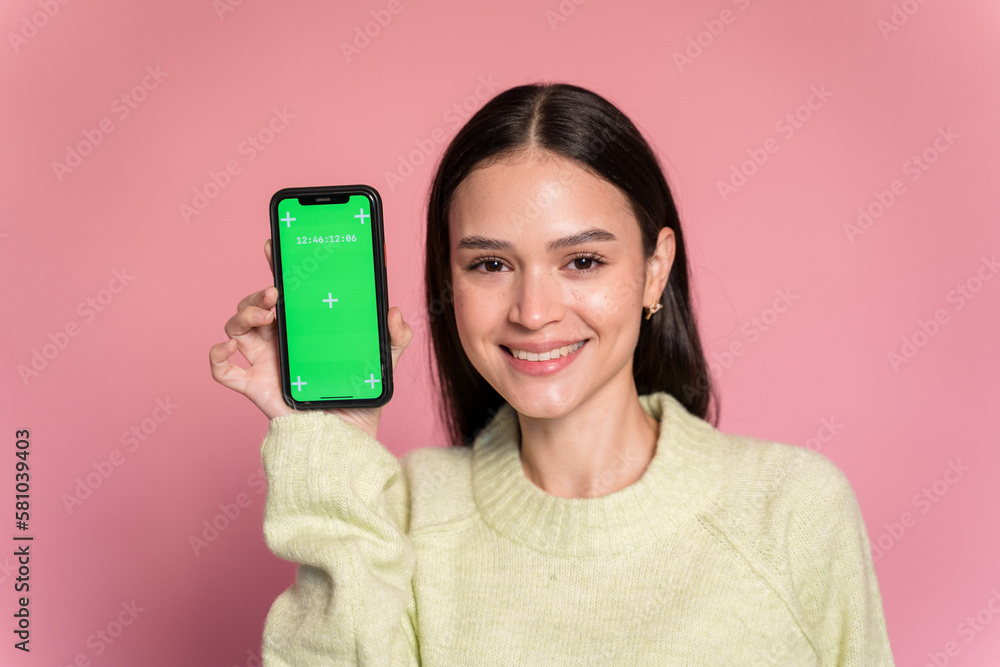 Smiling woman showing smartphone with croma screen Smiling woman showing smartphone with croma screen