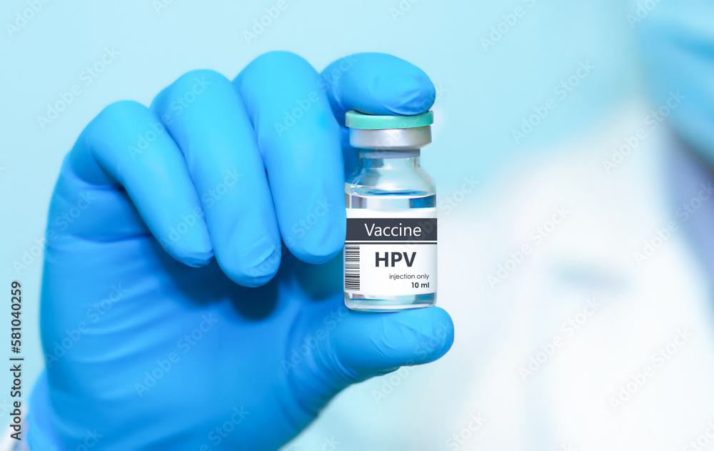 Doctor in protective gloves holding a HPV (human papillomavirus) vaccine .The concept of medicine, healthcare and science Doctor in protective gloves holding a HPV (human papillomavirus) vaccine .The concept of medicine, healthcare and science