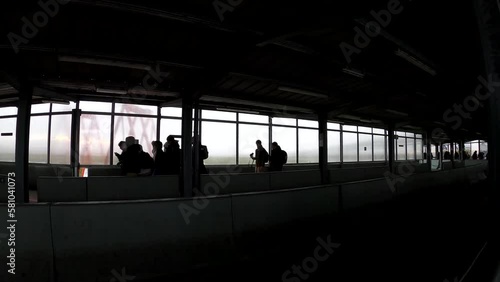 Silhouette view of travelers walking in the outside airport terminal after flight landing - Brussels international airport, Belgium photo