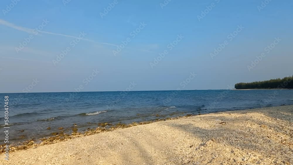 Beautiful white sand seascape sunset beach with calm wave at Tuban, East Java, Indonesia. Tranquil coastline scenery Beautiful white sand seascape sunset beach with calm wave at Tuban, East Java, Indonesia. Tranquil coastline scenery