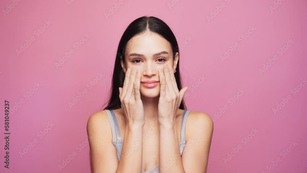 Smiling woman in underwear looking at camera on pink background Smiling woman in underwear looking at camera on pink background