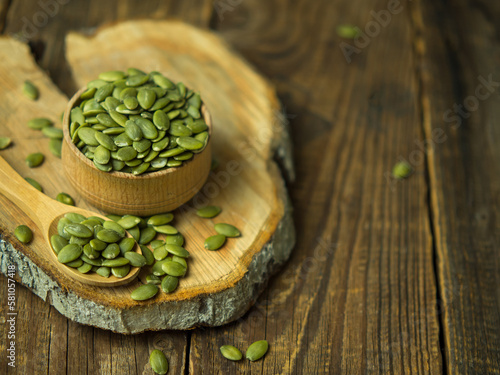 raw pumpkin seeds on old wooden background ,copy space