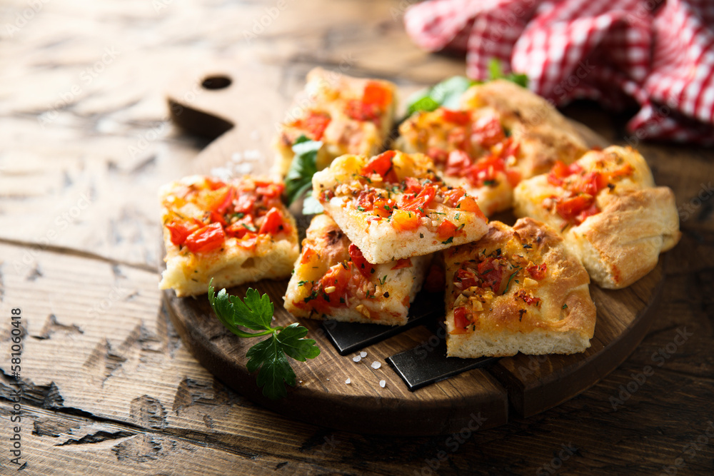 Traditional homemade focaccia with tomatoes Traditional homemade focaccia with tomatoes