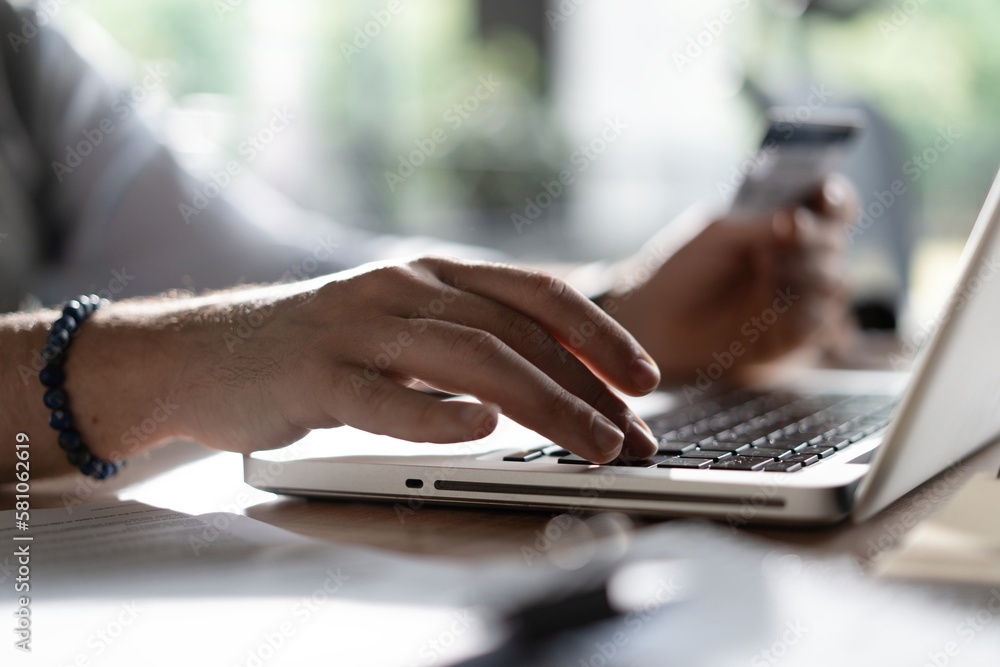 Online payment. Man's hands holding a credit card and using smart phone for online shopping. Online payment. Man's hands holding a credit card and using smart phone for online shopping.