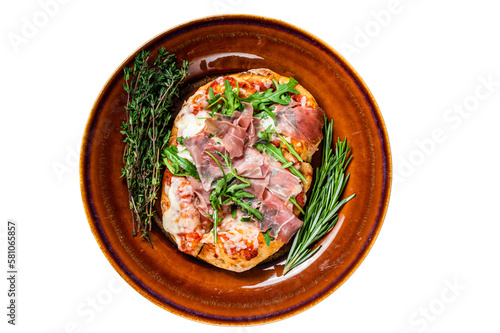 Pizza with prosciutto parma ham, arugula salad and parmesan cheese in a rustic plate.  Isolated, transparent background. photo