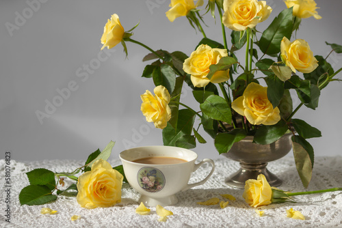 Wallpaper Mural Still-life with porcelain cup of coffee, yellow garden rose flowers on pin frog in vintage vase on white lace tablecloth Torontodigital.ca