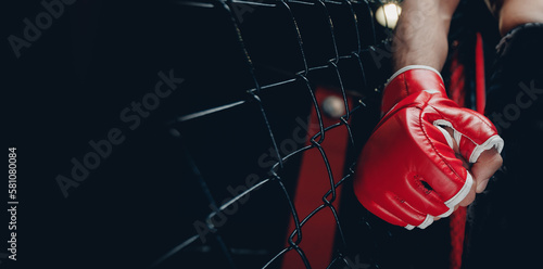 Closeup red Gloves for MMA of Boxers fighter in octagon. Concept sport banner, dark color