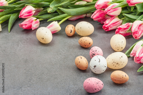 Easter flat lay with colorful eggs and tulips. Traditional decor, festive greeting card, holiday