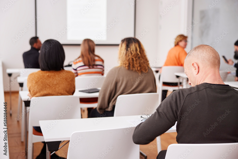 © Johnér - Rear view of people sitting at seminar