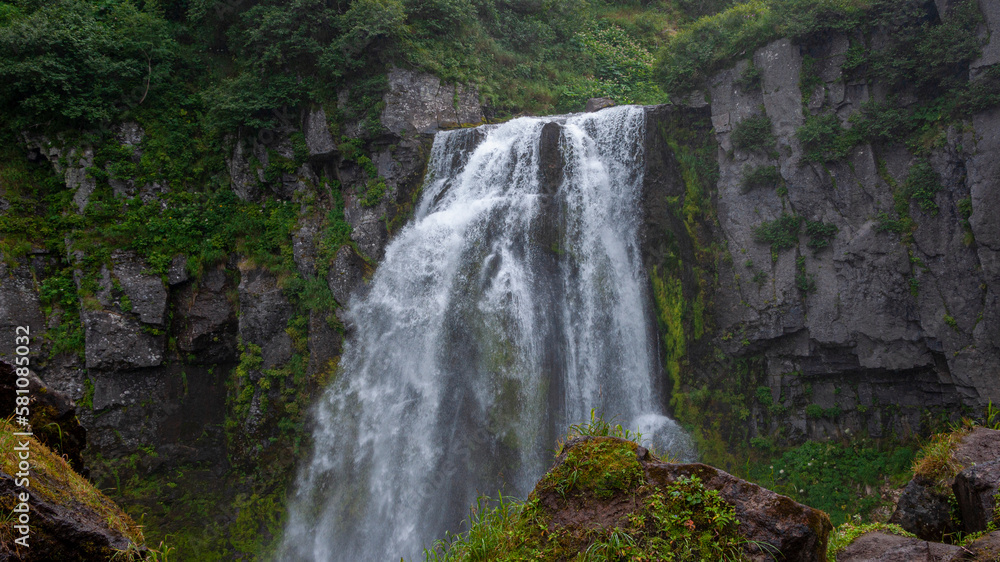 Fototapeta premium Russia, Kamchatka. A full-flowing mountain waterfall near Tolbachik volcano.