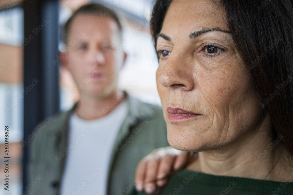 Man touching mature woman's arm