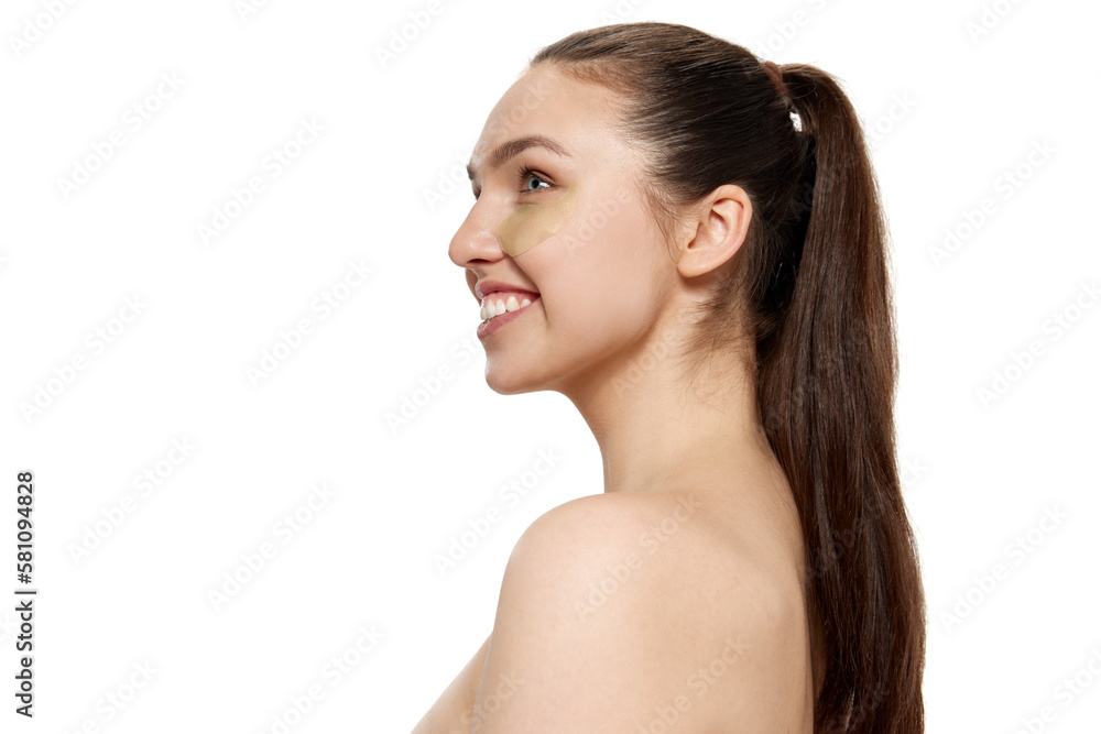 Happy beautiful young woman with smooth clean face skin looking up over white background. Concept of spa, beauty, skincare, cosmetology, healthy look Happy beautiful young woman with smooth clean face skin looking up over white background. Concept of spa, beauty, skincare, cosmetology, healthy look