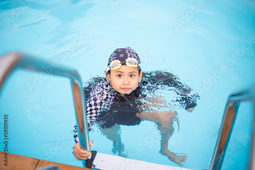 Asian little girl in the swimming pool photo