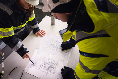 Engineers checking plans at building site photo