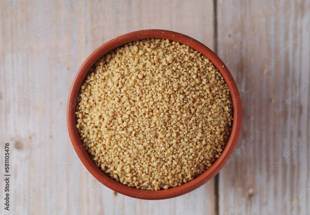 Dry couscous in a small ceramic bowl Dry couscous in a small ceramic bowl