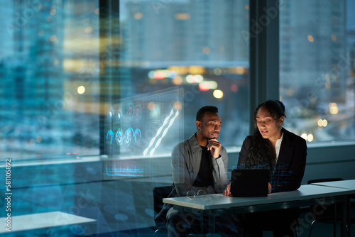 Two young business people working together in office