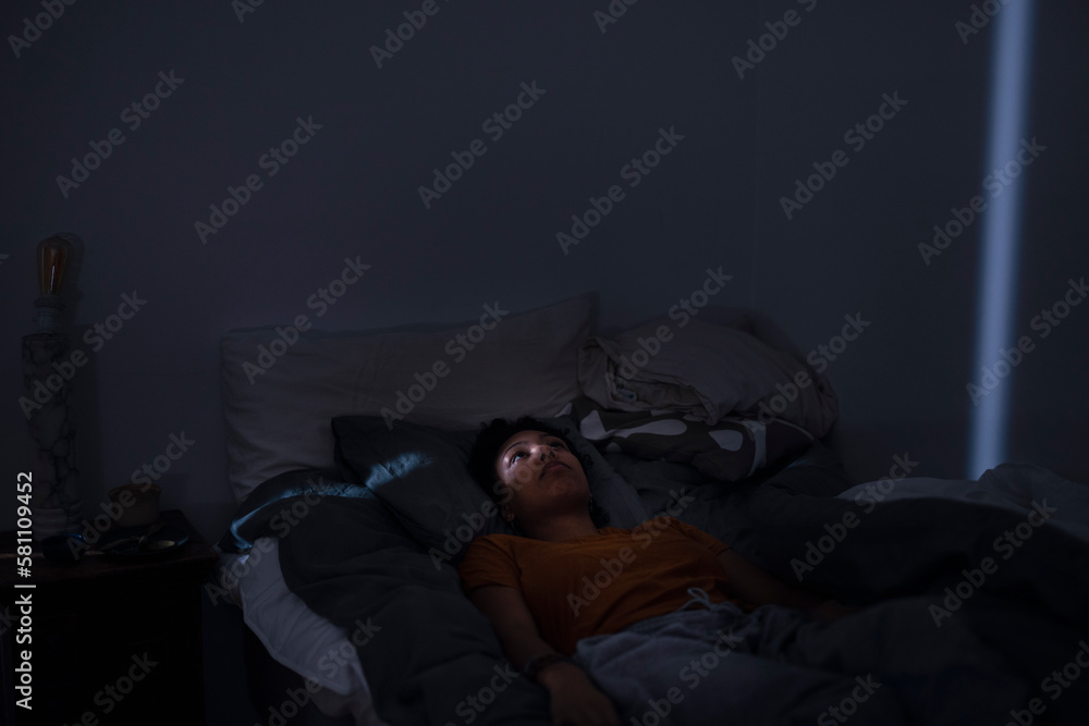 Pensive young woman lying in bed Pensive young woman lying in bed