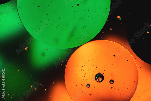 Microbubbles in mixed water and oil background, colorful abstract yellow - green led lights, super-macro abstraction