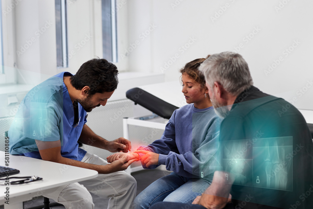 Male doctor examining girl patient's wrist during appointment Male doctor examining girl patient's wrist during appointment