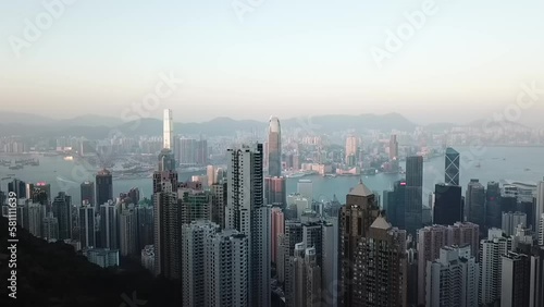 Wallpaper Mural Aerial shot of skyscrapers in city with sea against sky during sunset, drone flying over modern buil Torontodigital.ca