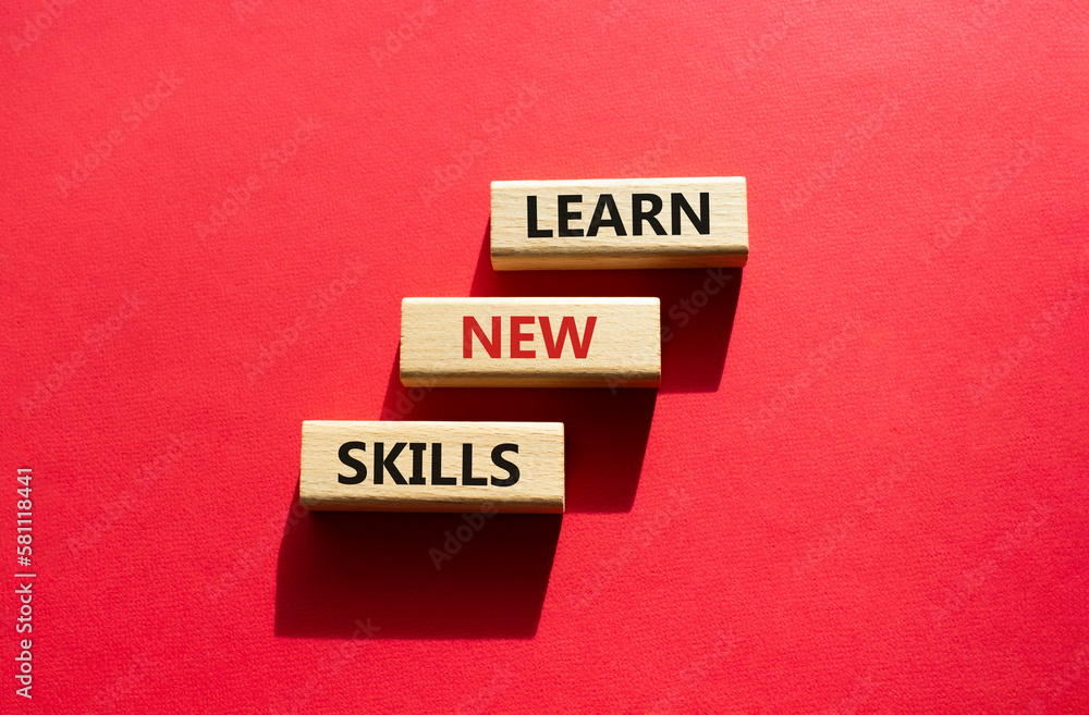 Learn new skills symbol. Concept words Learn new skills on wooden blocks. Beautiful red background. Business and Learn new skills concept. Copy space. Learn new skills symbol. Concept words Learn new skills on wooden blocks. Beautiful red background. Business and Learn new skills concept. Copy space.