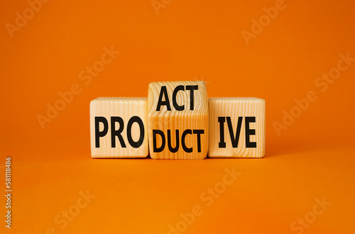 Proactive and Productive symbol. Turned wooden cubes with words Productive and Proactive. Beautiful orange background. Business concept. Copy space