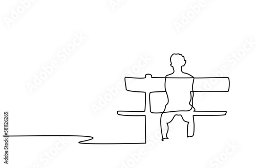 young boy sitting alone on the bench in the park