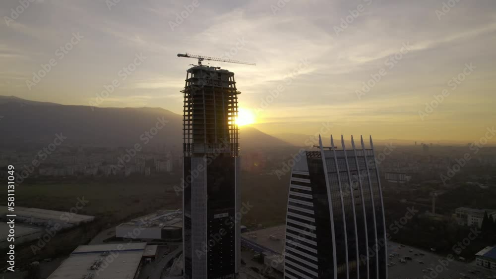 high-rise office building bathed in the warm hues of a gorgeous sunset ...