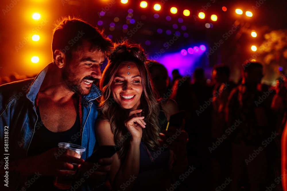 Couple takes selfie at summer concert.
