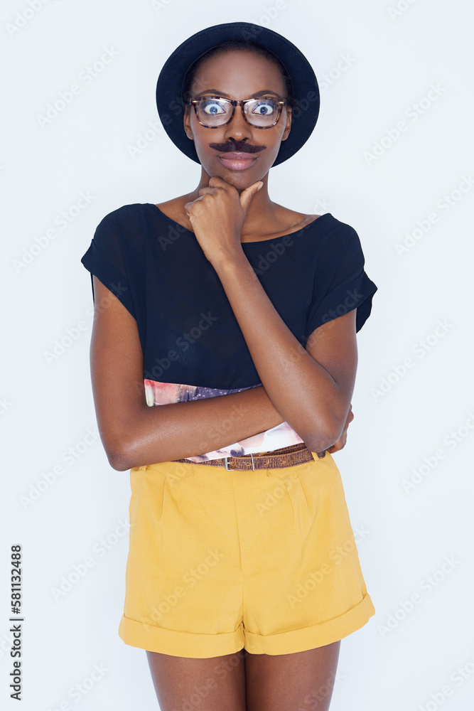 Expressing her childlike side. A young woman posing against white.