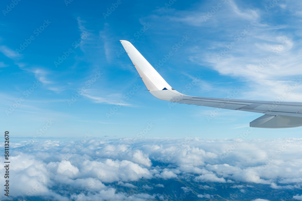 View of the blue sky and fluffy clouds from the window of the plane. View of the blue sky and fluffy clouds from the window of the plane.