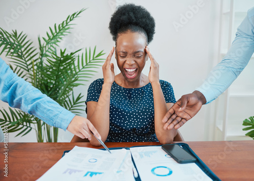 Young Black woman screams at work when deadline pressure builds up photo