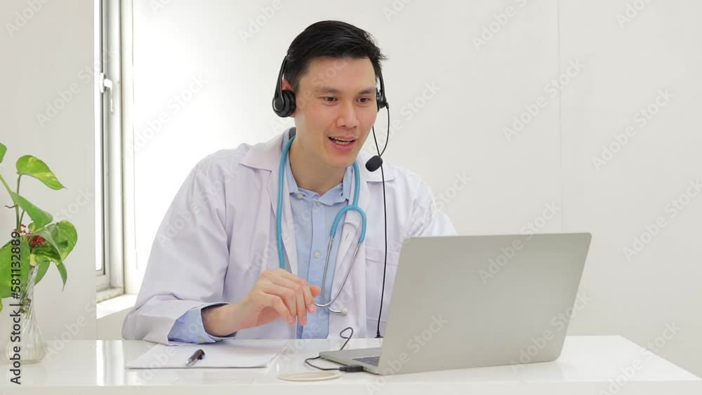 Asian male doctor treating patients online Talk via video call on laptop computer. Online treatment concept. Hospital medical services