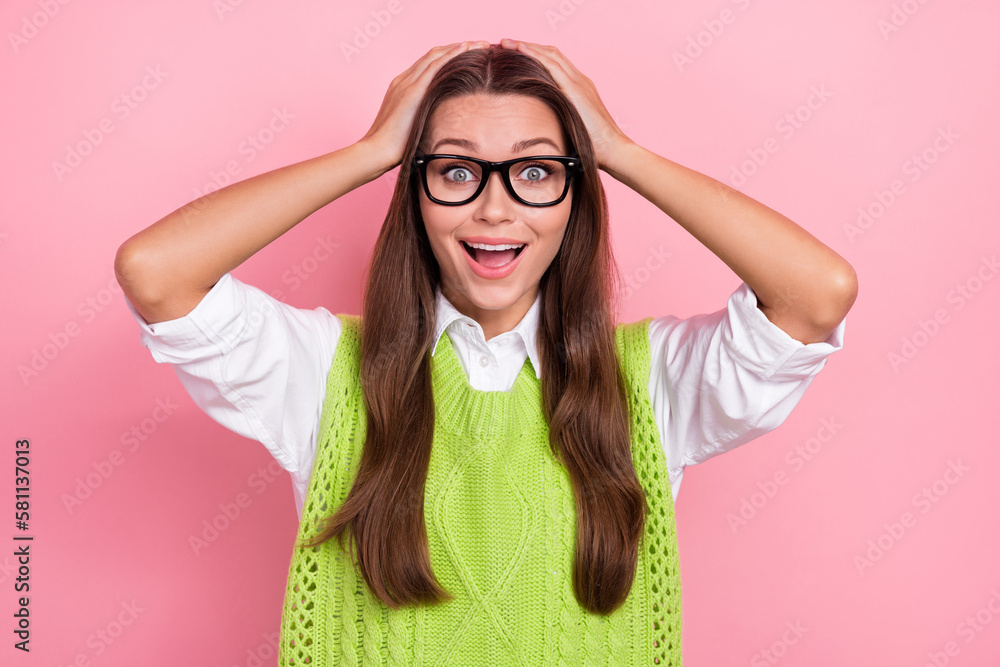 Photo of funny young teacher lady wear green cardigan hands touch head shocked university qualification growing isolated on pink color background Photo of funny young teacher lady wear green cardigan hands touch head shocked university qualification growing isolated on pink color background