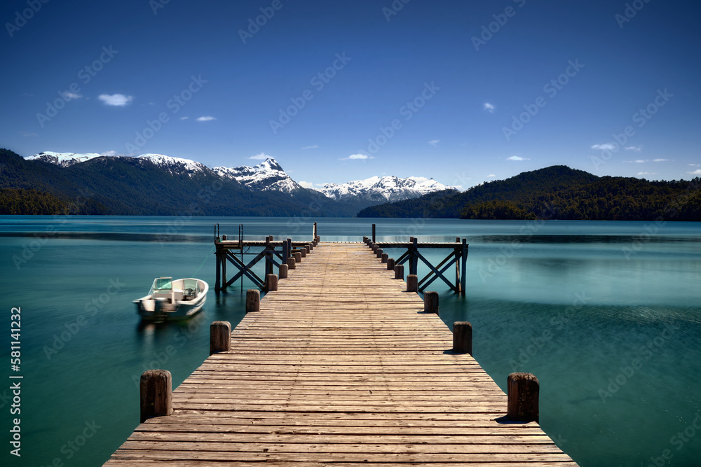 A beautiful pier on the lake in the morning with a boat. , Argentina