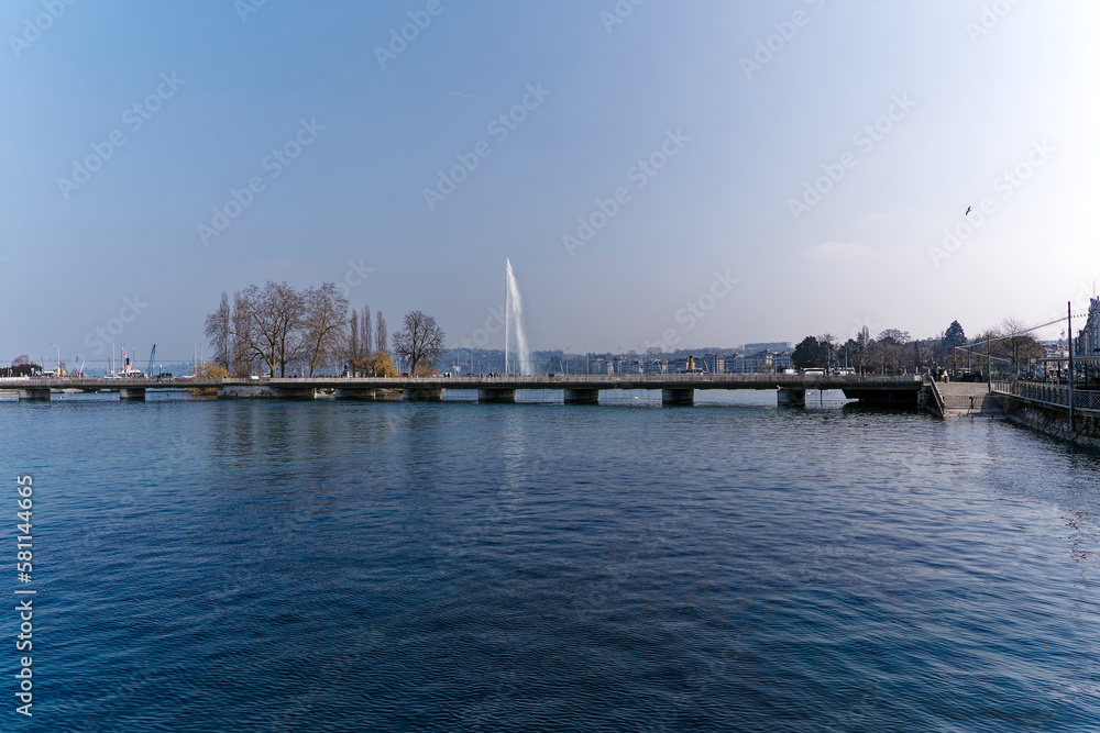 Rhone river with Mont Blanc Bridge and Lake Geneva in the background at Swiss City of Geneva on a sunny late winter day. Photo taken March 5th, 2023, Geneva, Switzerland.