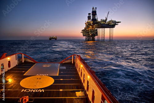 Anchor handing vessel  in the sea during cargo operations for offshore oil production platform. photo